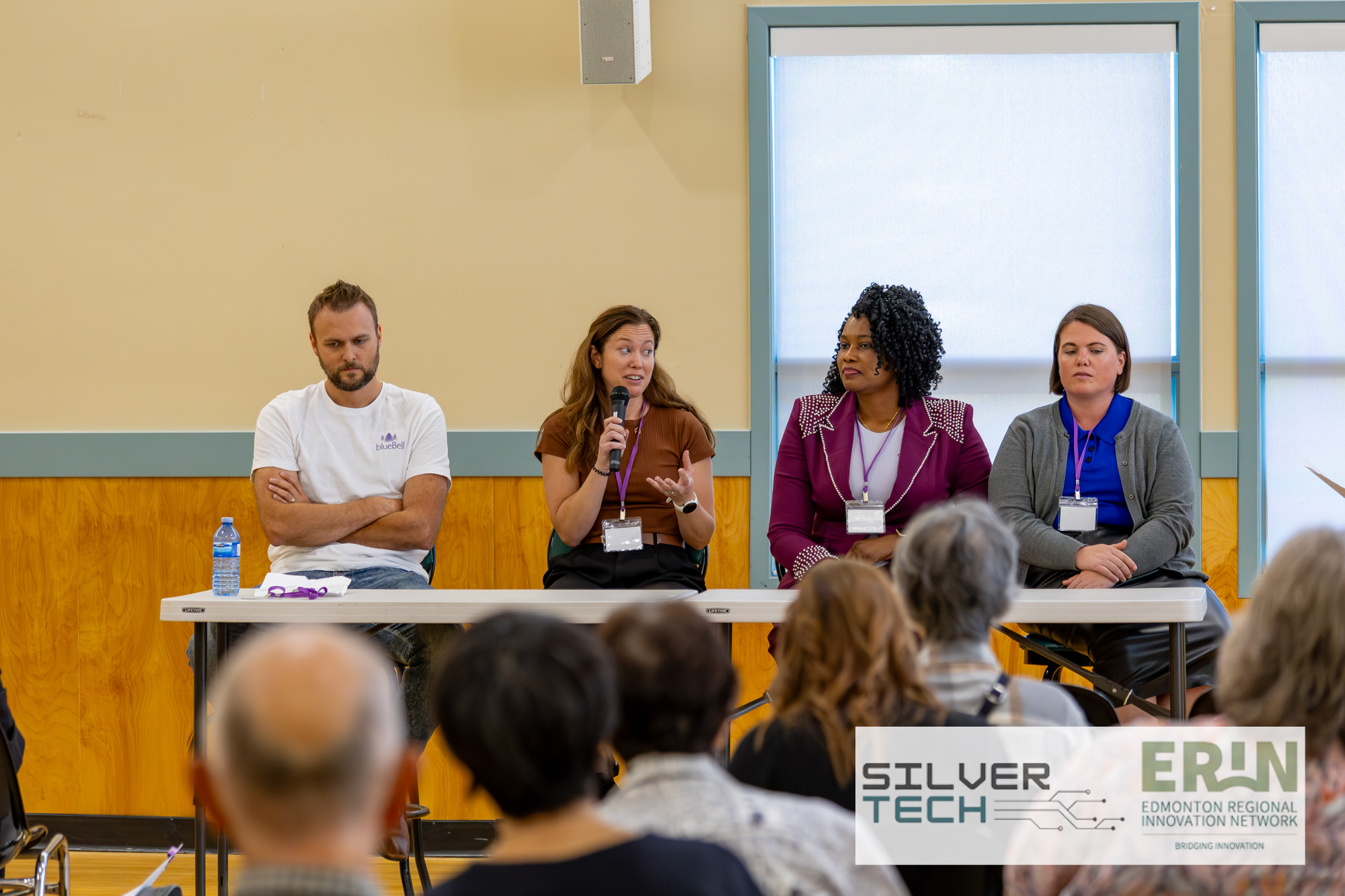 Four panellists seated at the front of the room during a SilverTech Summit panel discussion