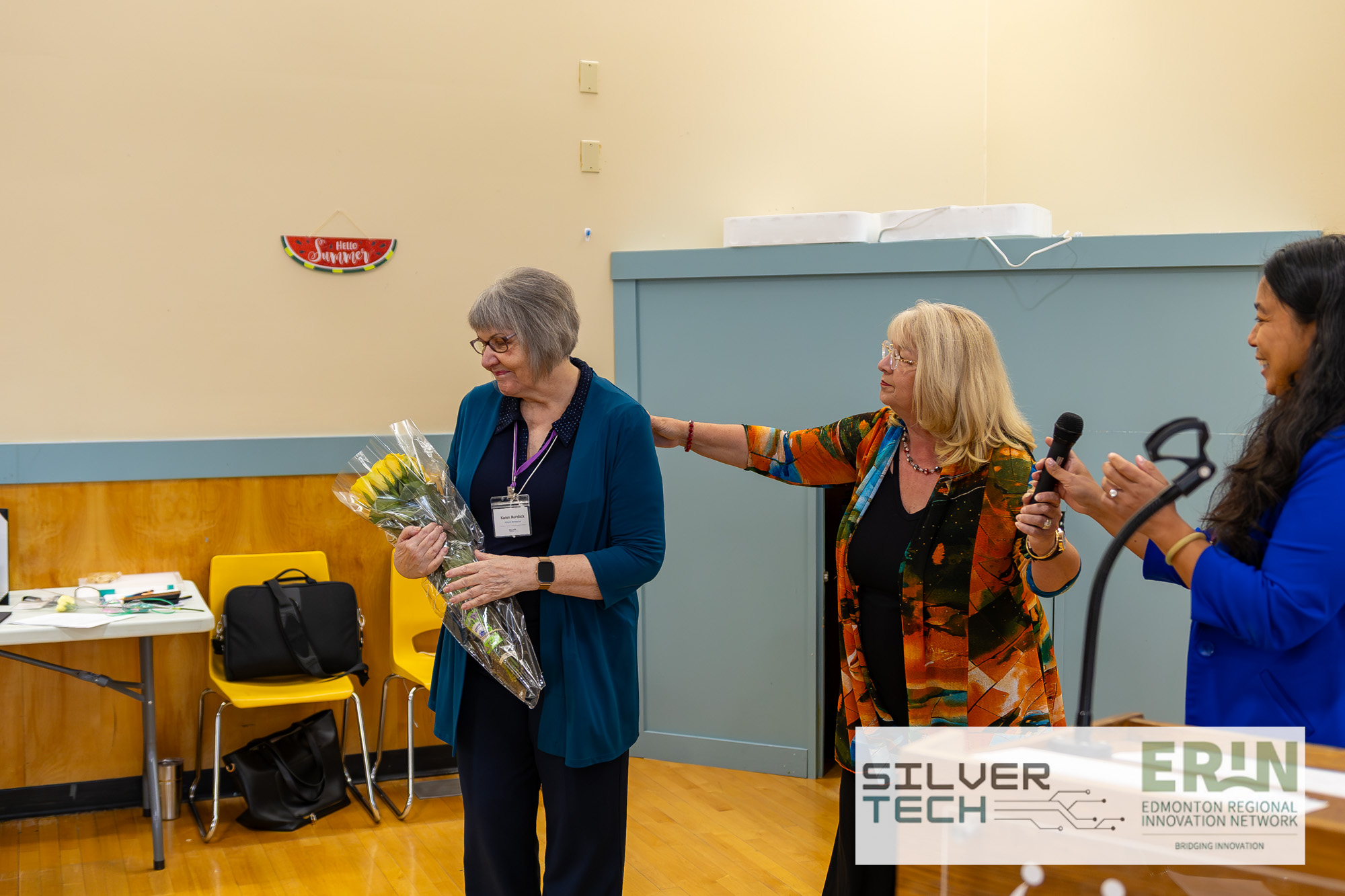 Closing moment with flowers presented to a speaker at the SilverTech Summit