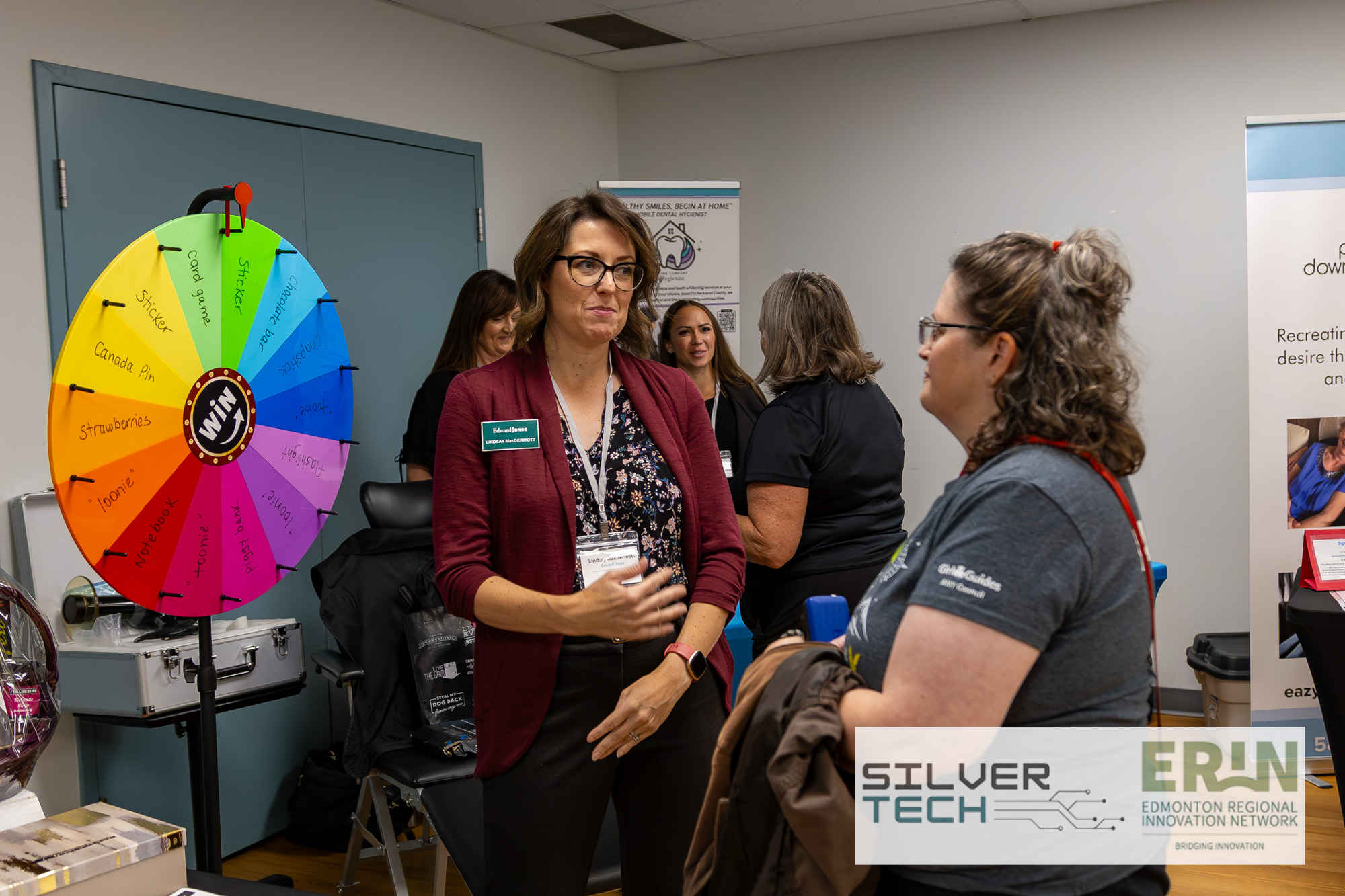 Edward Jones representative networking with an attendee beside the prize wheel