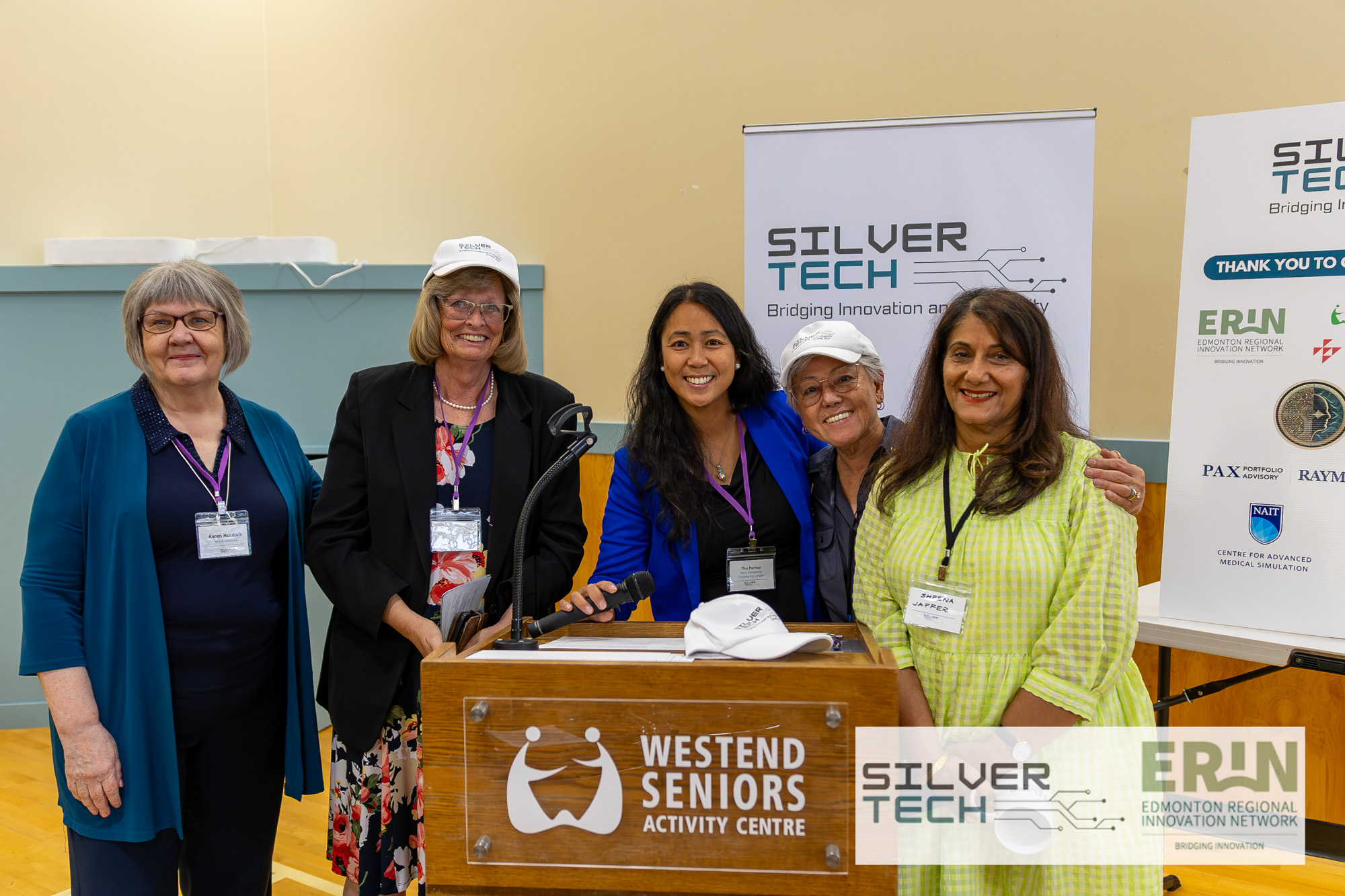 Group of community leaders gathered together at the SilverTech Summit podium