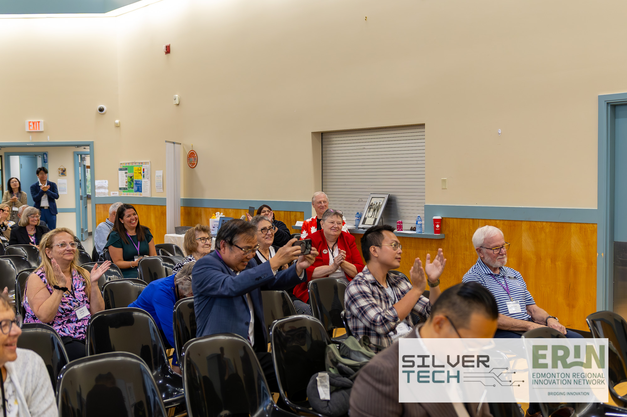Attendees applauding during a session at the SilverTech Summit