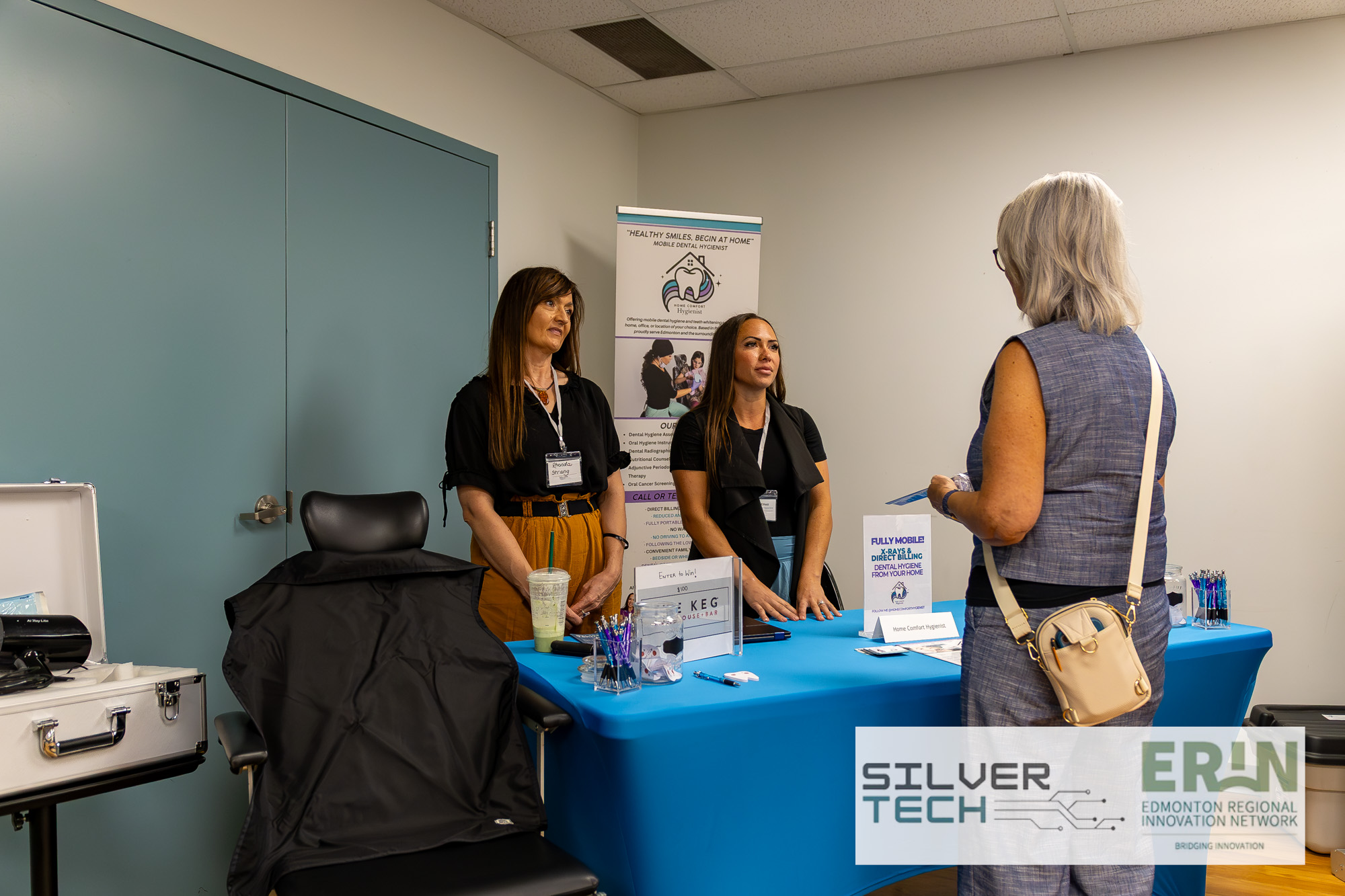 Home Comfort Hygienist exhibitor speaking with an attendee at their booth