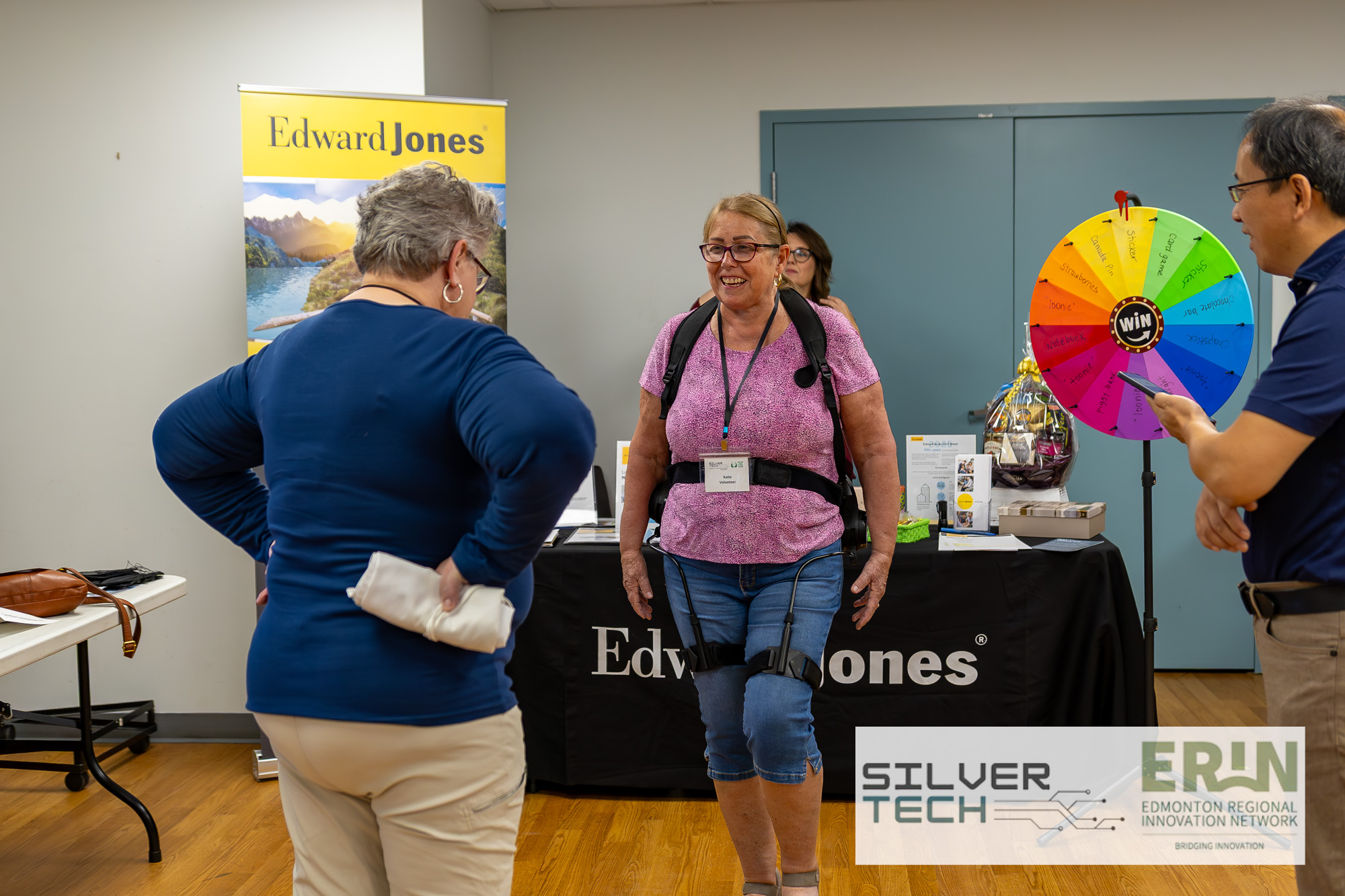 Volunteer trying on an Edward Jones aging-simulation suit at the Summit