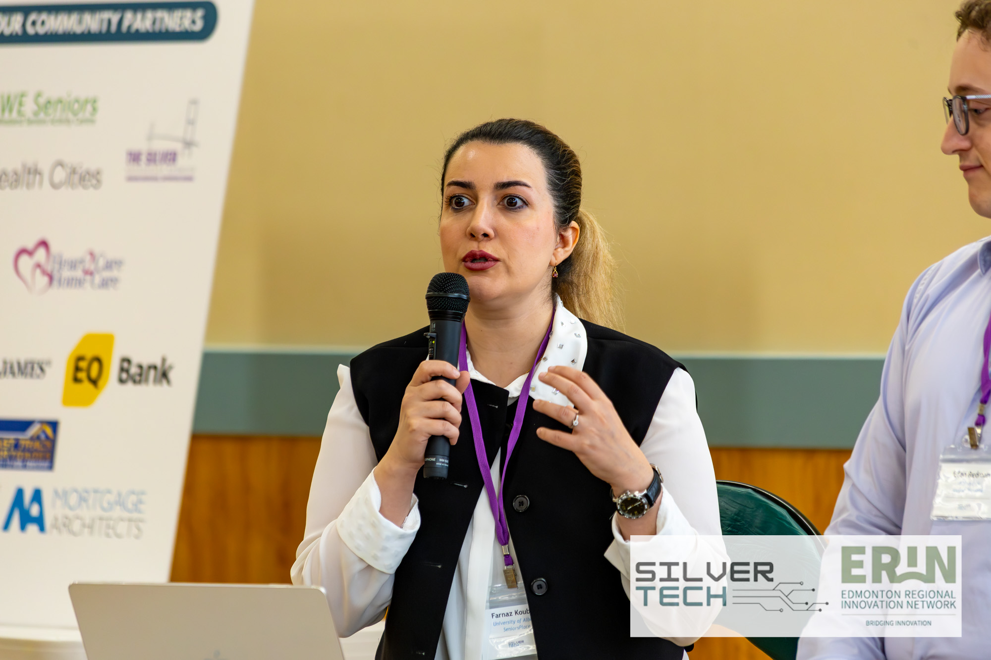 Panellist speaking into a microphone during a SilverTech Summit panel discussion