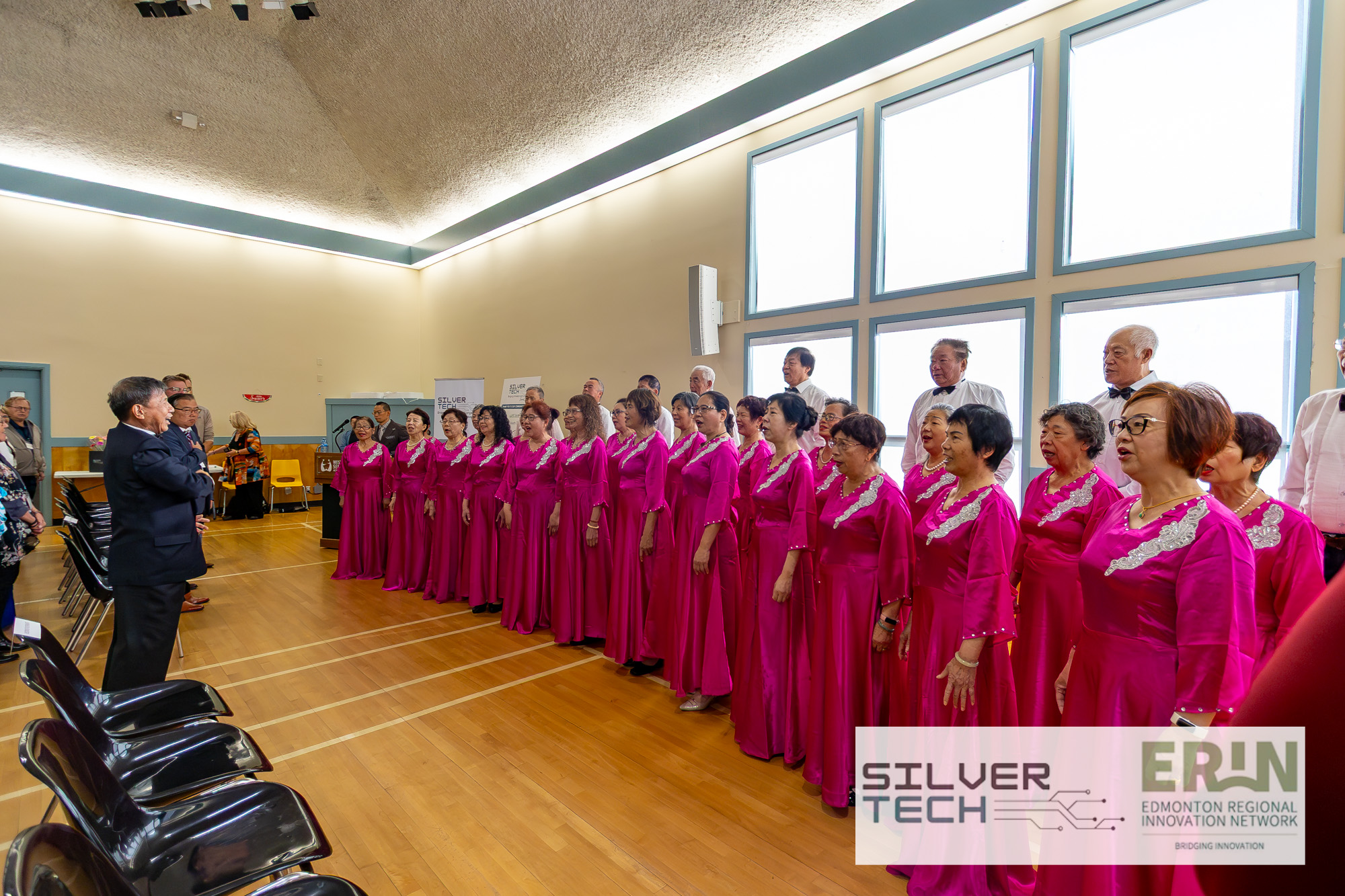 Choir in pink dresses performing at the SilverTech Summit opening