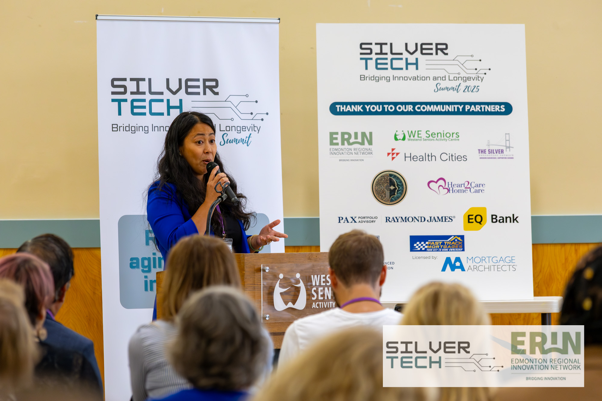 Community leader presenting in front of the SilverTech partner banner